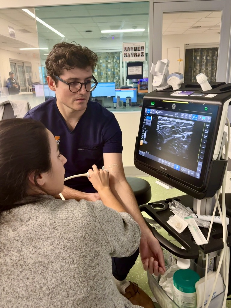 UVA Emergency Medicine fellow performing ultrasound-guided procedure on patient
